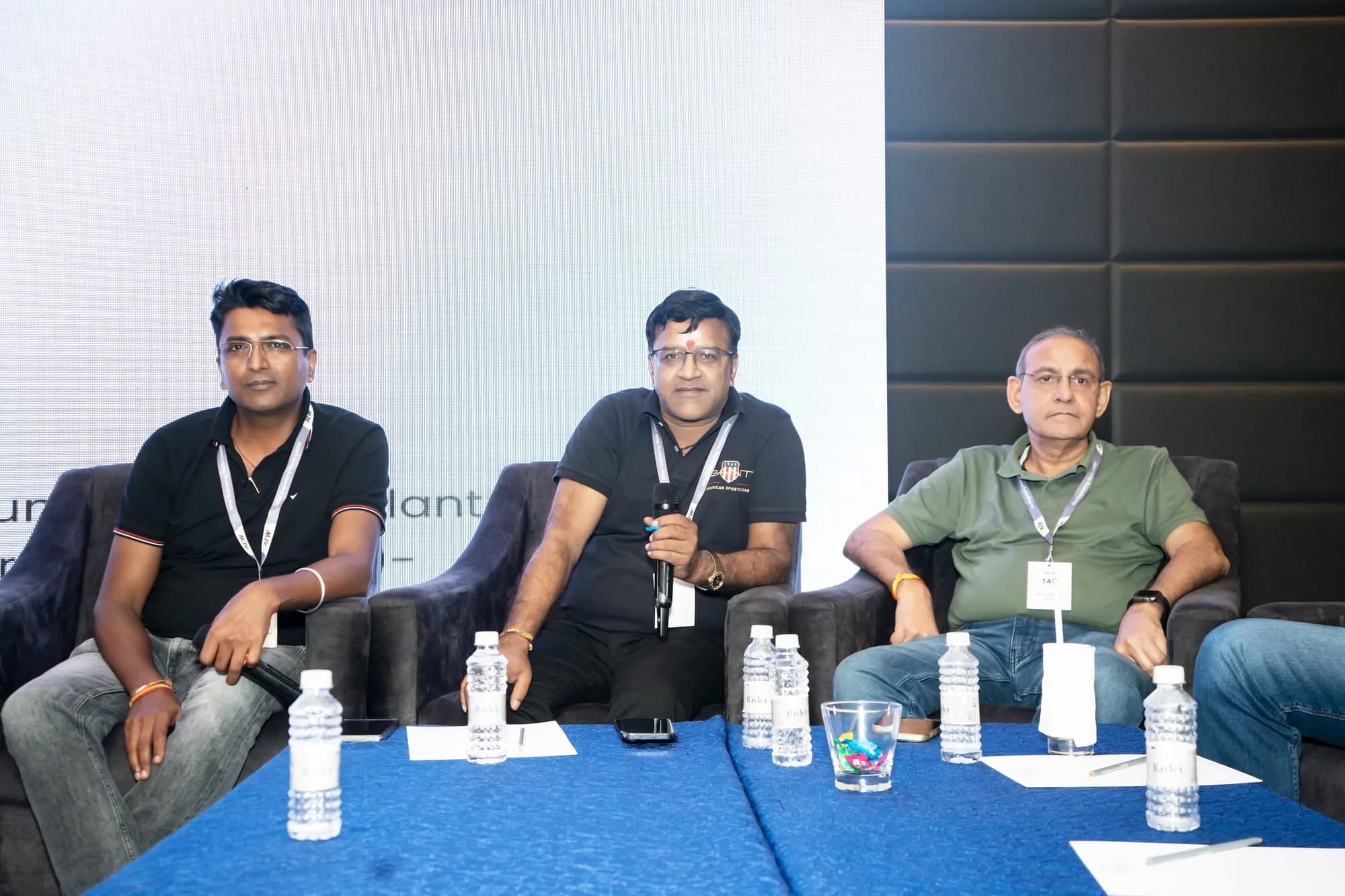 Panel speakers seated on stage during a corporate session